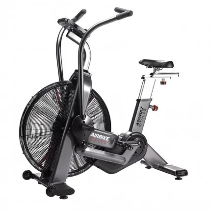 A person performing an intense full-body workout on the Bike Assault AirBike Elite, highlighting its robust construction