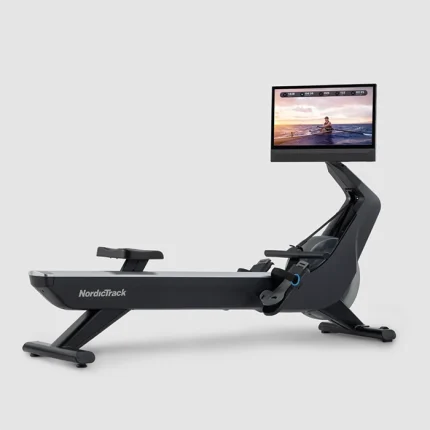 A person rowing on the Rower NEW RW900 NordicTrack, showing its large 24-inch touchscreen display