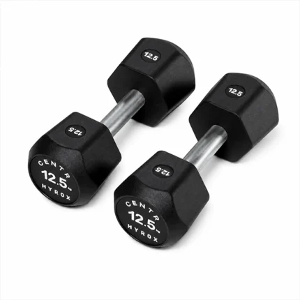 Pair of Centr x HYROX 12.5kg commercial urethane dumbbells on a gym floor Centr x HYROX Commercial Dumbbell
