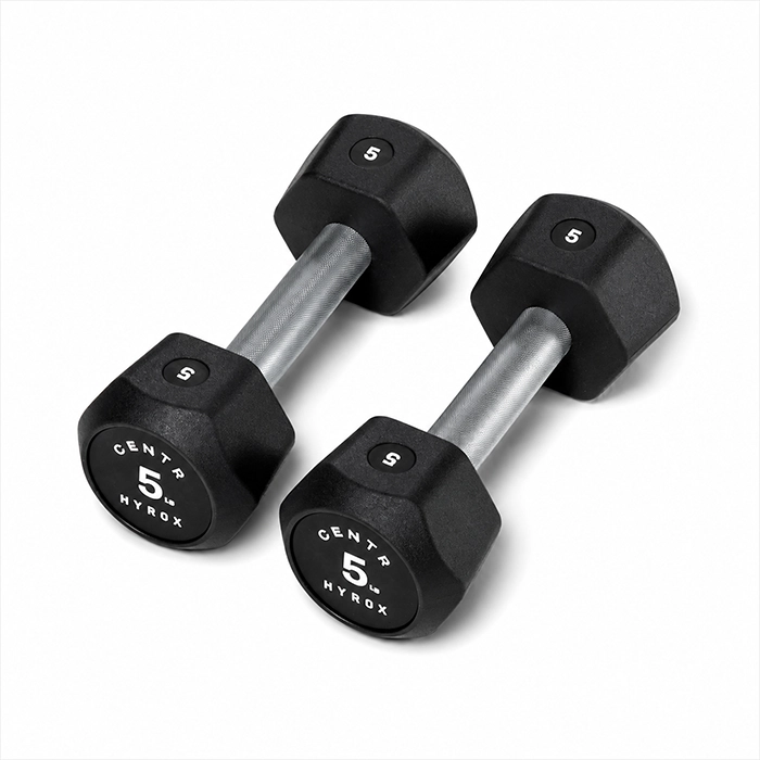 Pair of Centr x HYROX 5kg Commercial Dumbbell urethane dumbbells on a gym floor Pair of Centr x HYROX 5kg Commercial Dumbbell urethane dumbbells on a gym floor