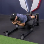 The Lower Body Floor Glute Hamstring Developer stored in its upright position, highlighting its space-saving design