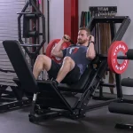 The Lower Body Leg Press Hack Squat Machine set up in the hack squat position, showing the shoulder pads and footplate